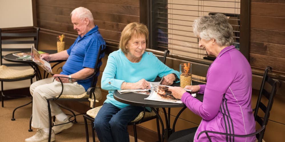 Senior living residents reading magazines at The Springs at Tanasbourne in Hillsboro, Oregon