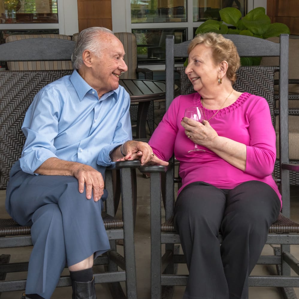 Resident chatting on the patio at The Springs at Carman Oaks in Lake Oswego, Oregon