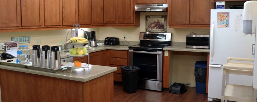 Kitchen in upscale senior living apartment with wood cabinetry at The Springs at Willowcreek in Salem, Oregon