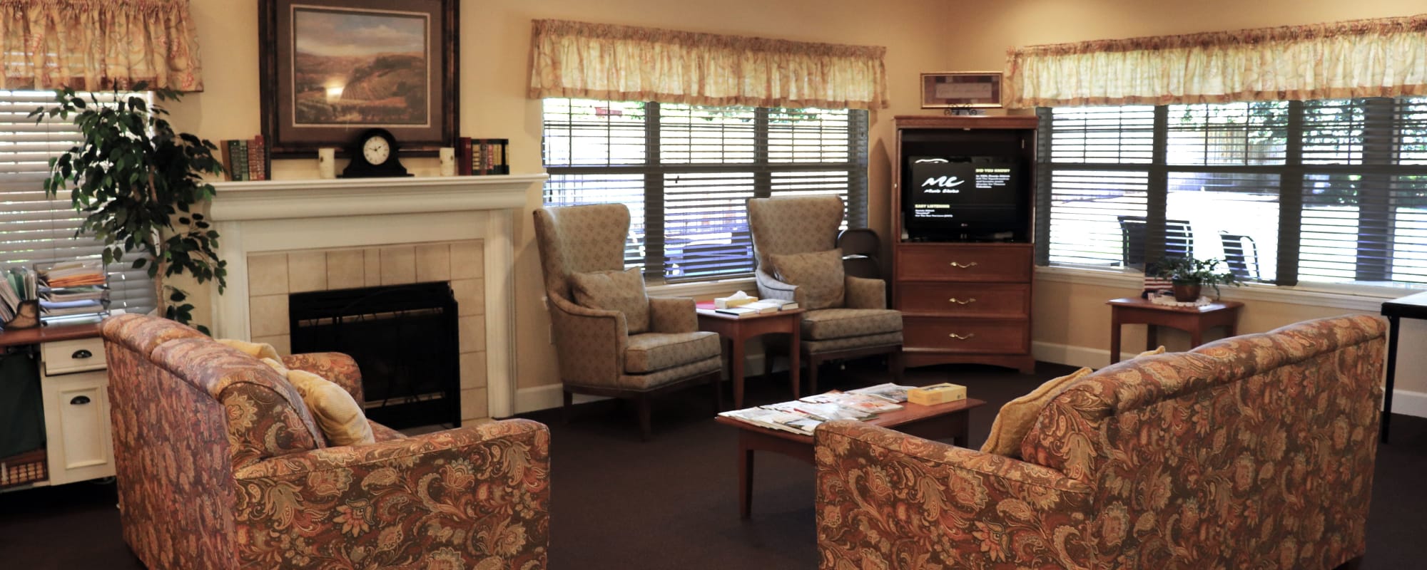 Cozy sitting area at upscale senior living facility complete with sofas, television set and fireplace at The Springs at Willowcreek in Salem, Oregon