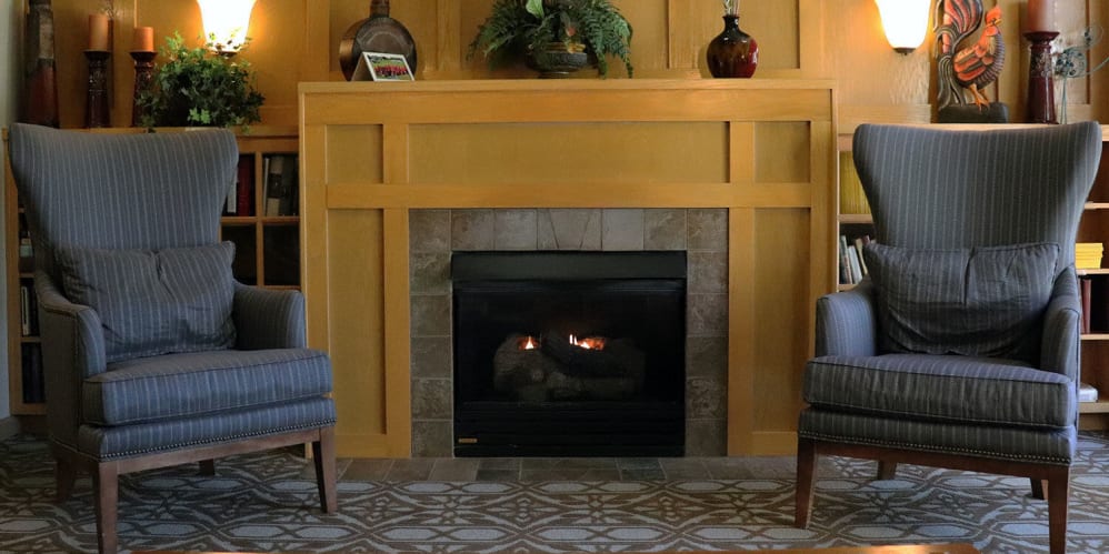 Comfy puzzle room complete with arm chairs and fireplace at The Springs at Sunnyview in Salem, Oregon-1
