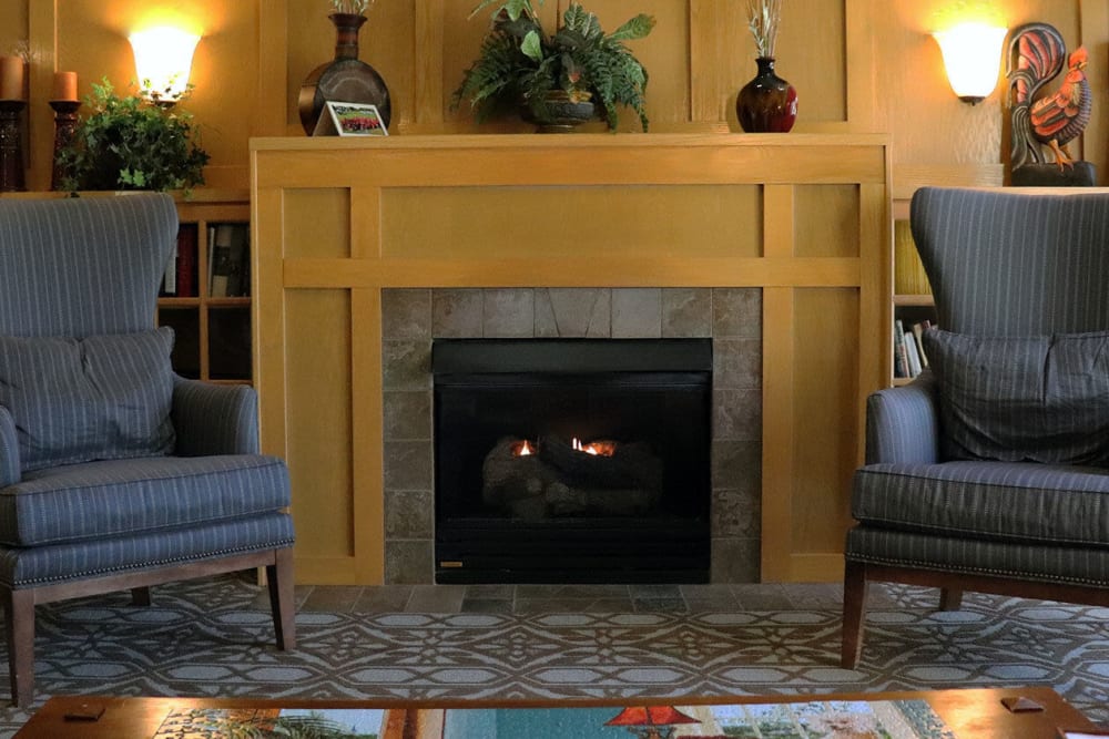 Upscale puzzle room complete with armchair seating and a fireplace at The Springs at Sunnyview in Salem, Oregon