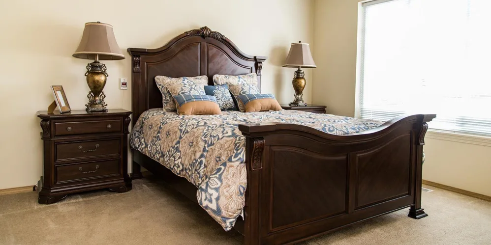 Upscale bedroom with wood detailing in independent living apartment at The Springs at Butte in Butte, Montana
