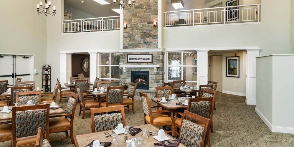 Elegant formal dining room with chandeliers at The Springs at Grand Park in Billings, Montana