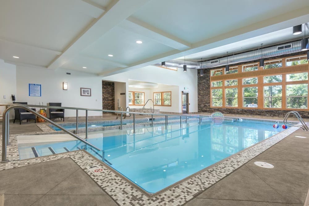 Indoor pool area with senior accommodation at The Springs at Greer Gardens in Eugene, Oregon