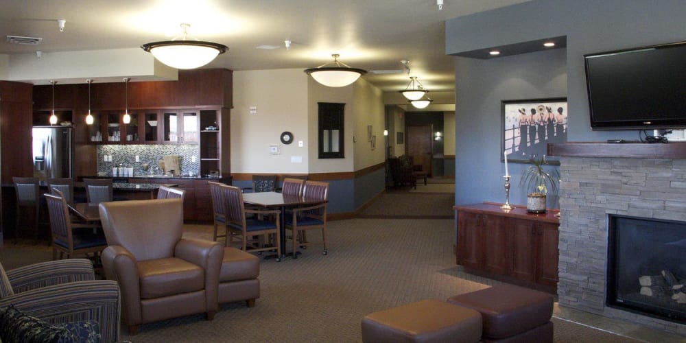 Classic communal lounge area with comfy leather armchairs, television and fireplace at The Springs at Mill Creek  in The Dalles, Oregon