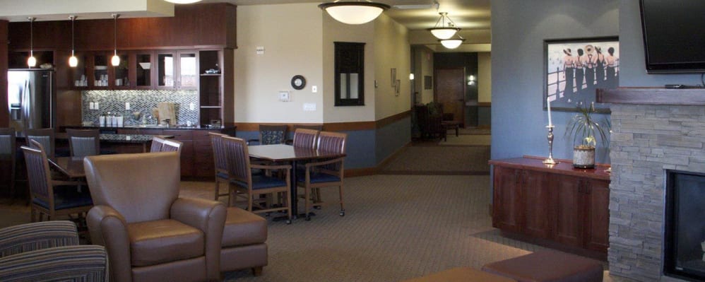 Classic common area lounge with leather arm chairs, television, and fireplace at The Springs at Mill Creek in The Dalles, Oregon