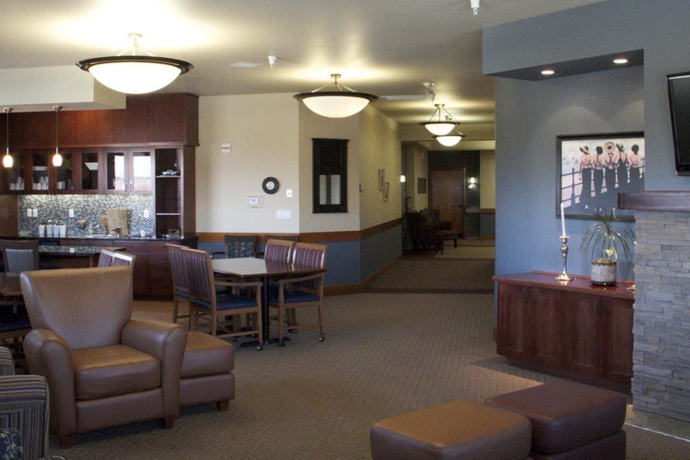 Front lobby at upscale senior living facility complete with leather arm chairs, television set, and fireplace at The Springs at Mill Creek in The Dalles, Oregon