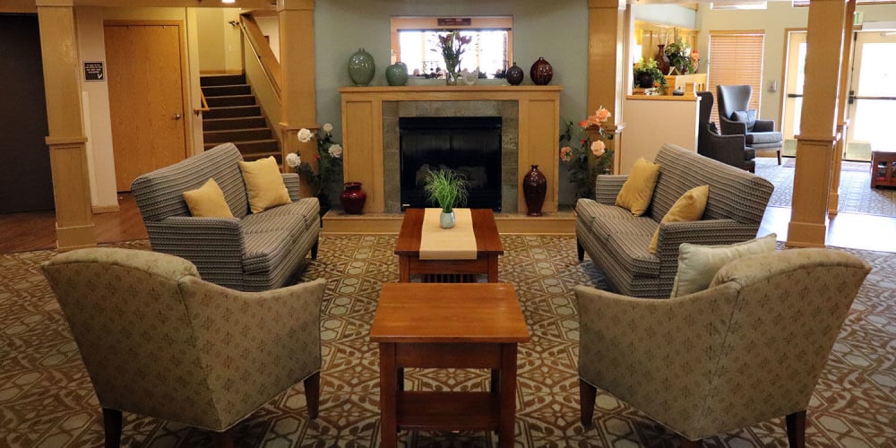 Comfy sitting area complete with flowers and fireplace in upscale senior living facility at The Springs at Sunnyview in Salem, Oregon