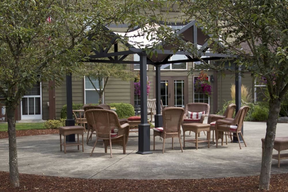Patio area complete with chairs and table in upscale senior living facility at The Springs at Sunnyview in Salem, Oregon