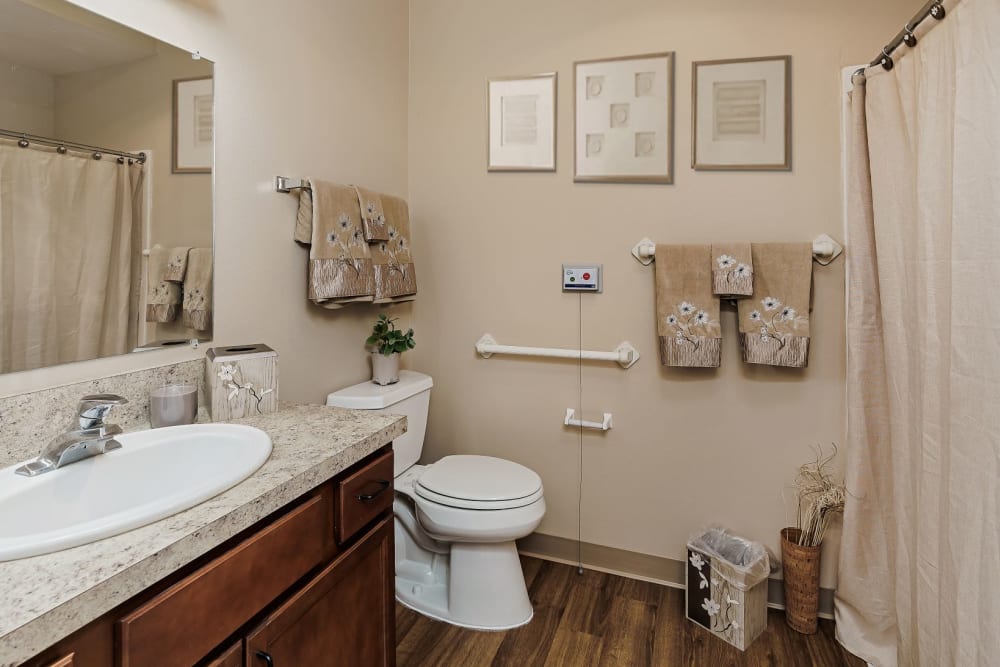 Spacious bathroom with hardwood floors in upscale senior living apartment at The Springs at Grand Park in Billings, Montana
