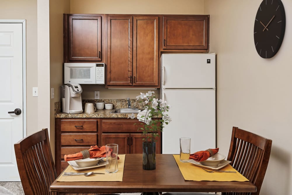Upscale kitchen with wood accents in senior living apartment at The Springs at Grand Park in Billings, Montana