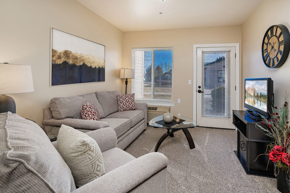 Luxurious yet comfy living room in senior living apartment at The Springs at Grand Park in Billings, Montana